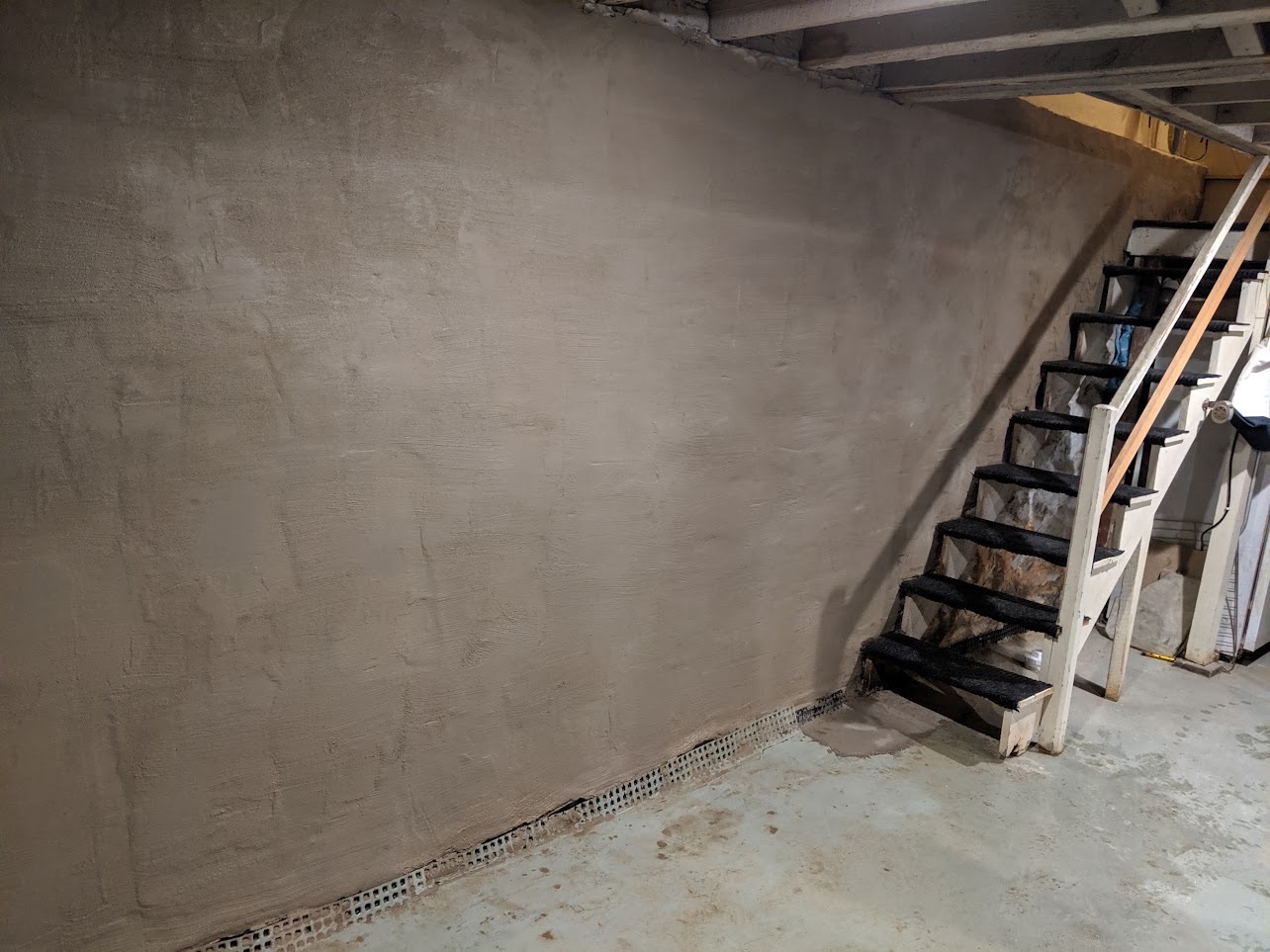Interior drainage and wall vapor barrier installation in Maryland basement