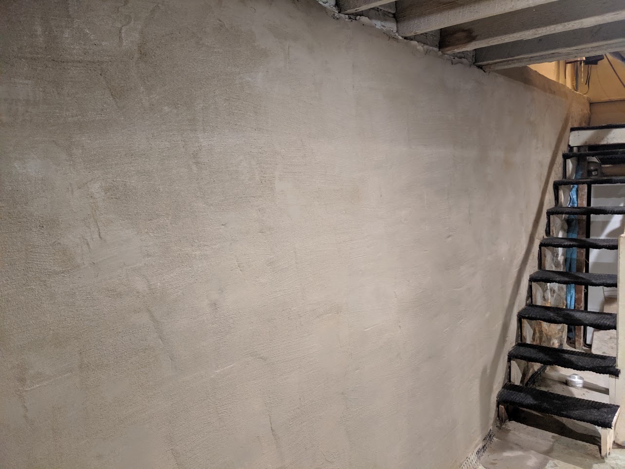Finished hydraulic cement crack repair in repaired basement wall