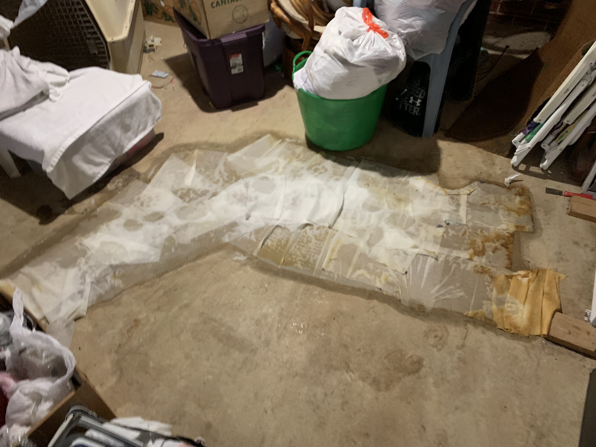 Wet concrete basement floor with water damage
