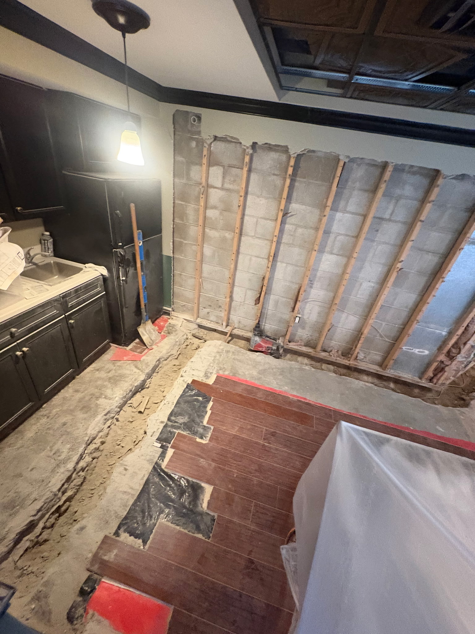 Interior drainage trench at footer of block foundation wall