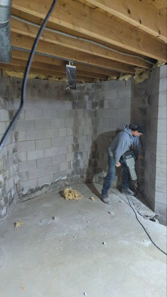 OBW technician using jackhammer for basement perimeter cut