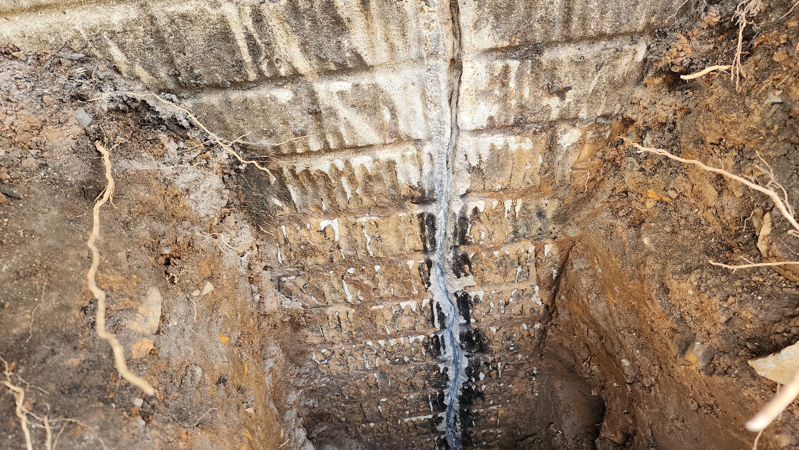 Vertical crack in Maryland block basement wall with active water leakage
