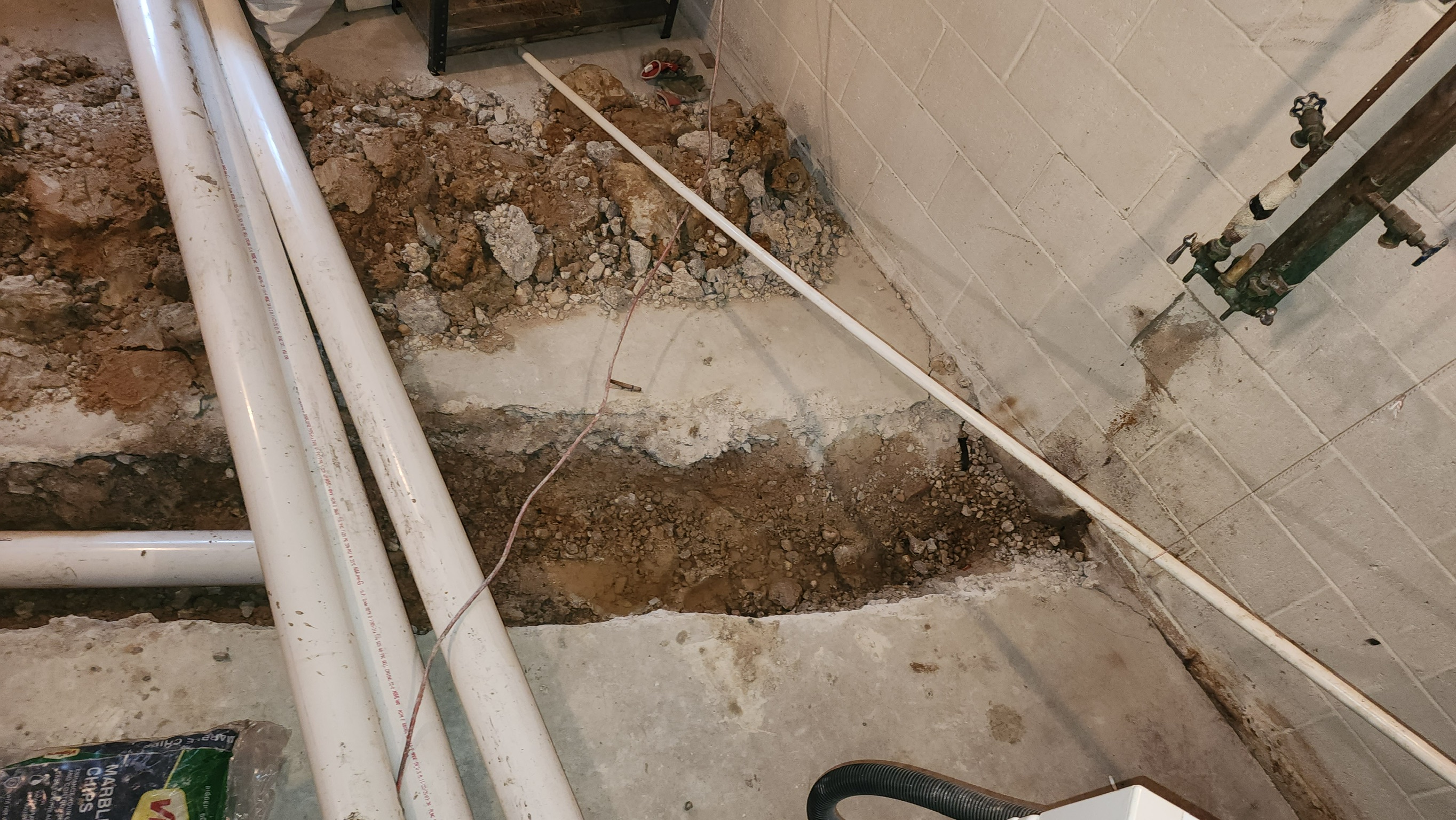 PVC drainage pipe installation alongside Maryland foundation