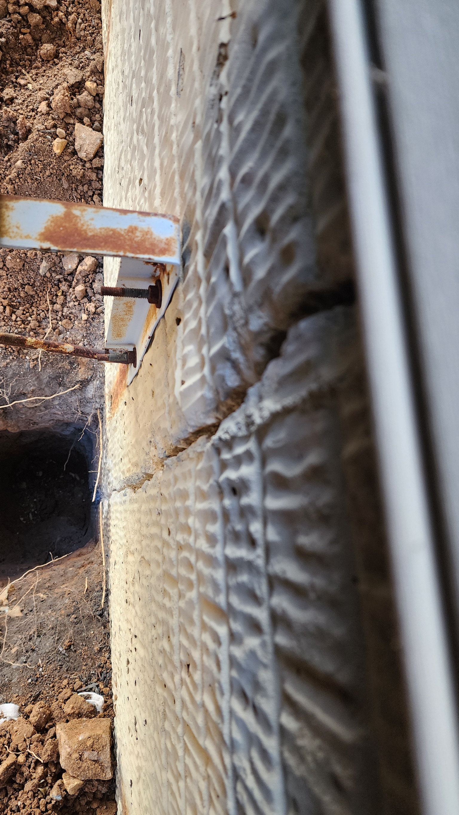 OBW inspector examining foundation crack during excavation